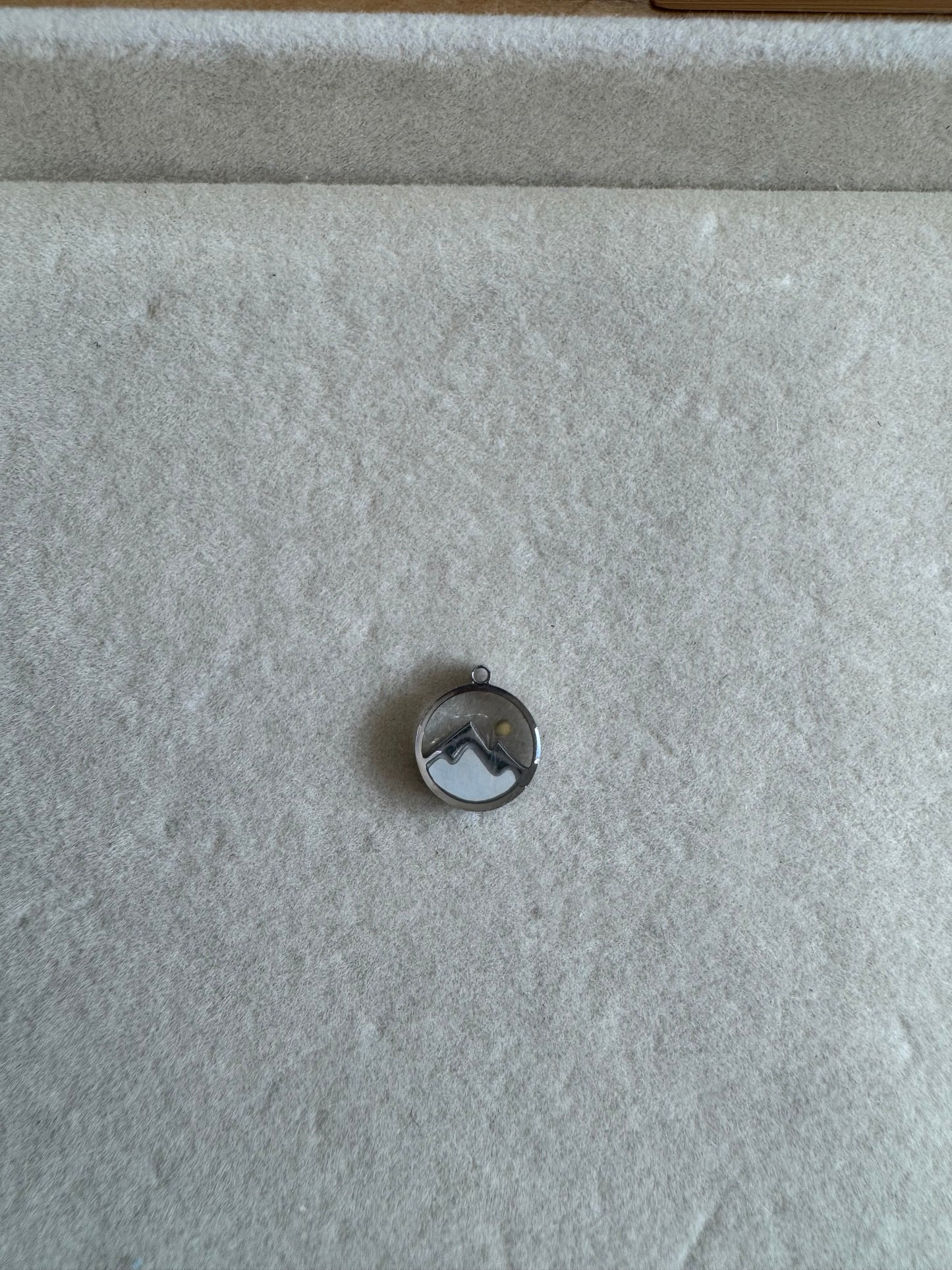 Silver mustard seed charm