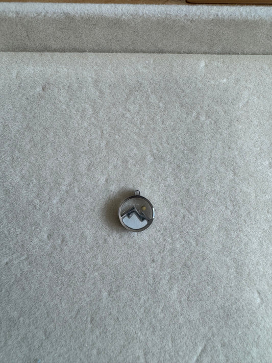 Silver mustard seed charm